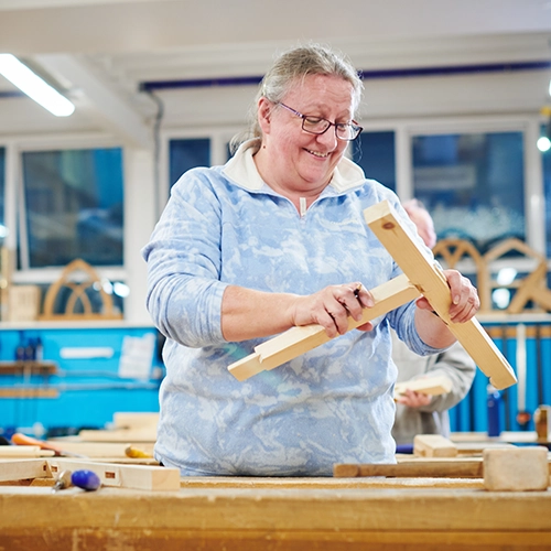A student assembling some wooden parts