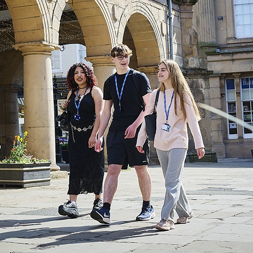 A student sketching at a desk
