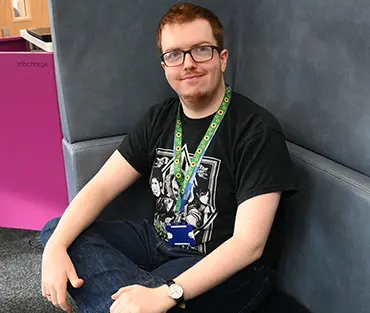 Student sitting on chair looking to camera