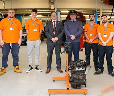 Four Engineering Apprentices standing next to Curriculum leader and Pilot Officer