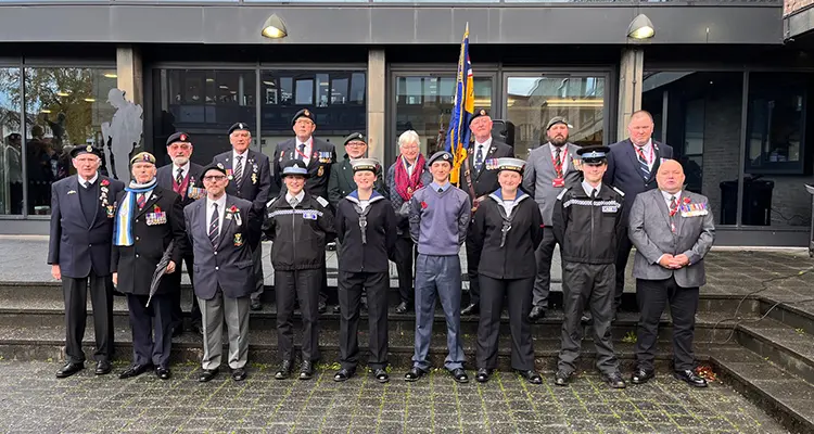 Staff and veterans standing outside college
