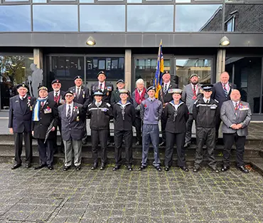 Staff and veterans standing outside college