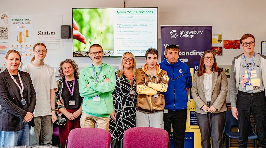 A group of students in front of a presentation screen