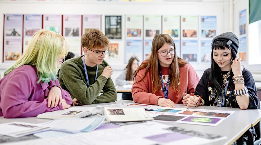 Four students reviewing work
