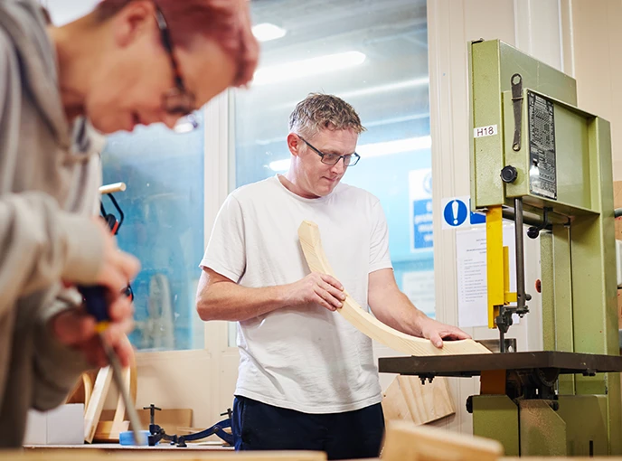 Man shaping wood on bandsaw